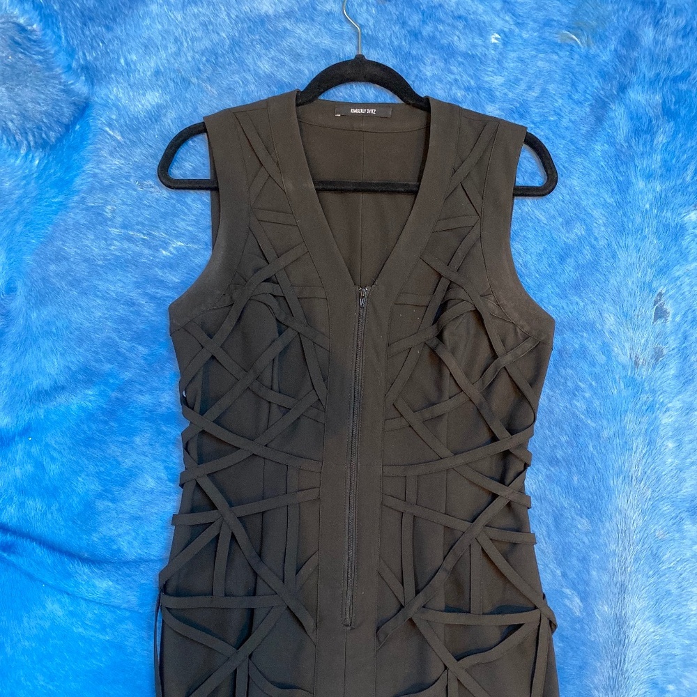 Black minidress with intricate bands of fabric on the front of the dress.